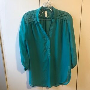 Teal green blouse with lace accents.